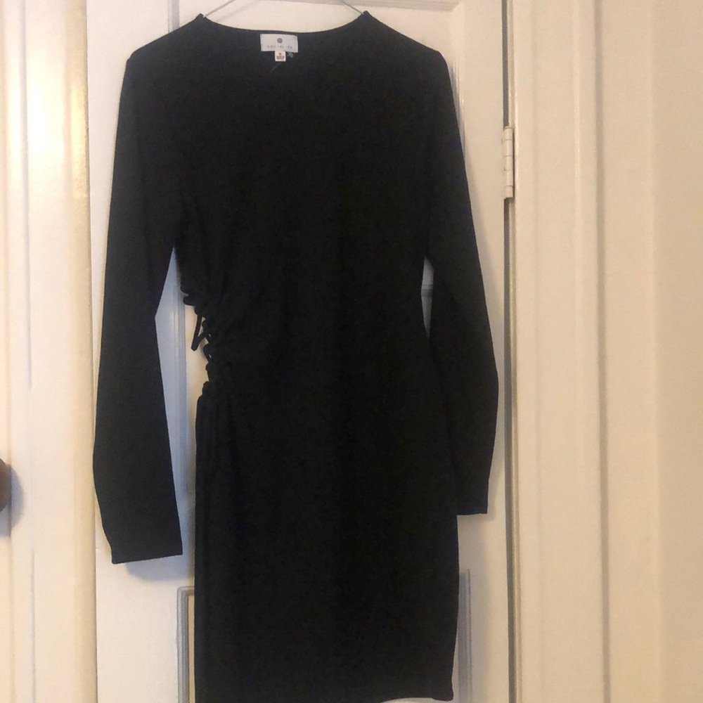 Never worn right stretchy black dress with tie side that is adjustable